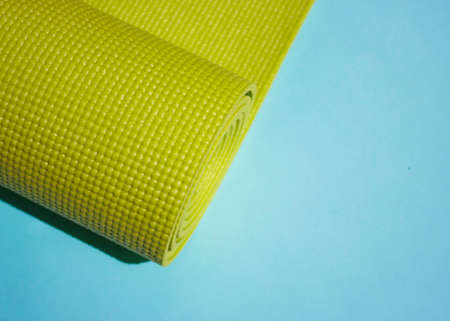 A green yoga pilates exercise mat rolled up. International Yoga Day June 21st. love yoga.Sport indoors.の写真素材