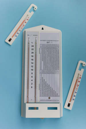 Psychrometric hygrometer isolated on blue background.simple device for measuring air humidity in a...