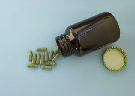 Chlorella in capsules super food. vegetable dietary Supplement Chlorella.capsules are poured out of the bottle.の写真素材