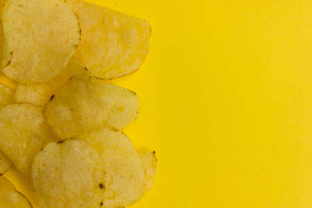 some potato chips on a yellow background.
