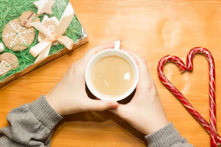 Christmas breakfast, coffee mug with gingerbread star cookies, with christmas gift or present, on...