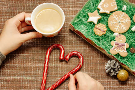 Christmas breakfast, coffee mug with gingerbread star cookies, with christmas gift or present, on...