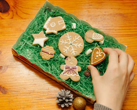 Christmas breakfast, coffee mug with gingerbread star cookies, with christmas gift or present, on...