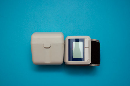 Automatic Wrist Digital blood pressure monitor on blue background