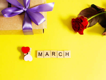 Small present box with flowers on a yellow background. Kraft paper. Suitable for International...