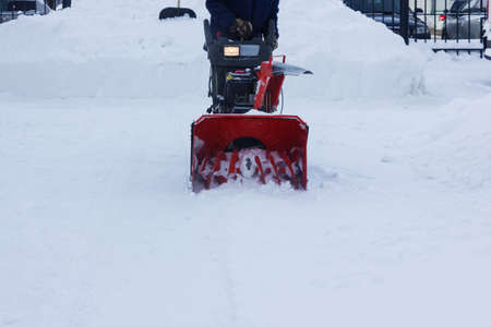 A snow thrower is the best assistant for snow removal in the winter.snow removal with snowplow.abnormal amount of snowのeditorial素材