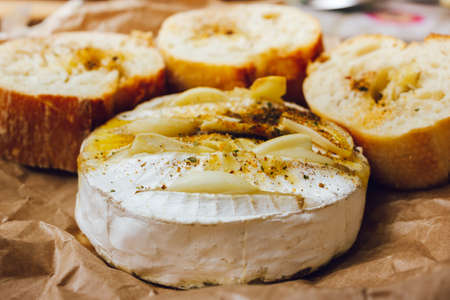 homemade DIY baked camembert with garlic.cheese with white mold.baked cheese.の写真素材
