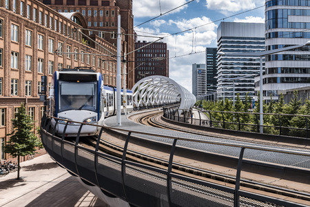 Intercity tram from Alstom running on an aerial tram station and plateforme in The Hague,...