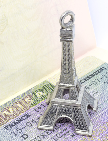 Close up of the Eiffel tower keychain on the Schengen visaの写真素材
