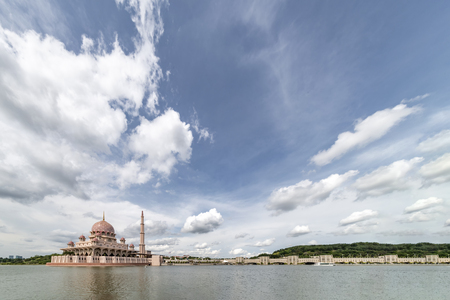Pink color Putrajaya mosque surrounded by water at Putra Jaya city, the Malaysian Federal Territory administrative city framed with place for text messagesのeditorial素材