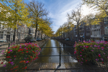 No bicycle parked on the bridge over the canal under the autumn lights of the early sunset, The Hague, Netherlandsの写真素材