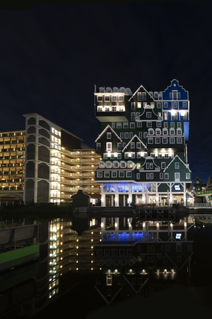 ZAANDAM, 20 January 2019 - Sunset on the Inntel hotel building made of all type of Dutch architectural style top up each other making this building unique in its gender, Zaandam city, Netherlandsのeditorial素材