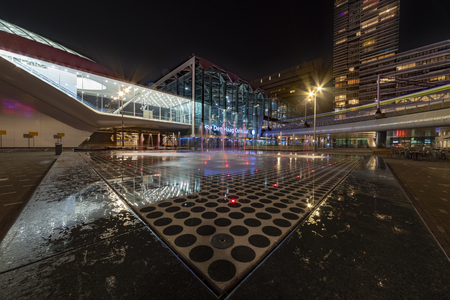 THE HAGUE, 30 March 2019 - Illuminated fountain with water jets in front The Hague Central train station at night, Netherlandsのeditorial素材