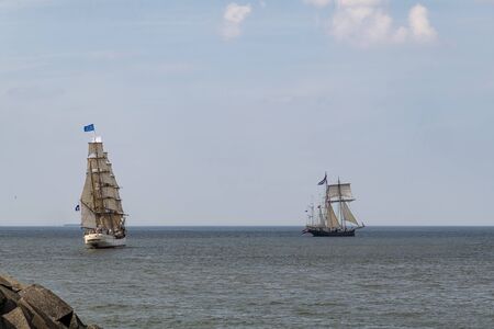 Antique tall ships, vessels leaving the harbor of The Hague, Scheveningen under a sunny and blue sky