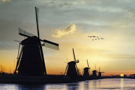 Twight light sunrise on the windmill silhouette at the middle of the canal, Alblasserdam, Netherlandsの写真素材