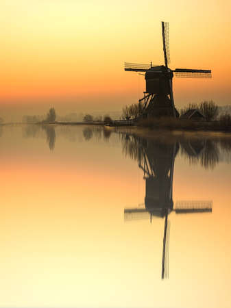 Twight light sunrise on the  windmill silhouette at the middle of the canal, Alblasserdam, Netherlandsの写真素材