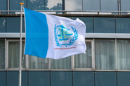 LEIDSCHENDAM, 18 August 2020 - Flag of the Special Tribunal for Lebanon (STL) floating and flying under the winds in from the building at the rendering day of Rafic Hariri killing judgement.のeditorial素材
