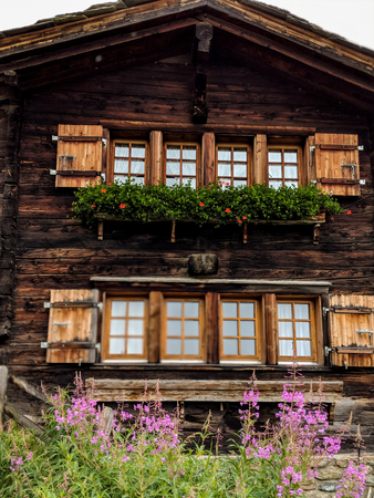 House decorated with flowers in Zermatt, alpine village, Switzerland, Swiss Alpsのeditorial素材