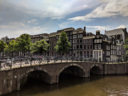 Beautiful view of Amsterdam canals with bridge and typical dutch houses. Hollandのeditorial素材