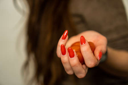 girl with red nails holding red tomatoesの写真素材