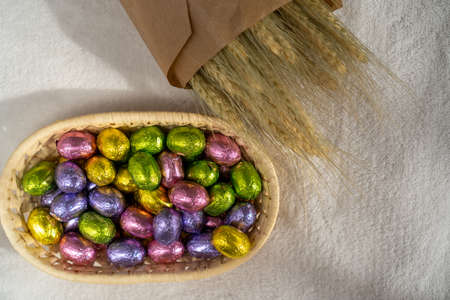 chocolate Easter sweets in a basket and dried flowersの写真素材