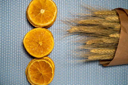 orange slices with a bouquet of dried flowersの写真素材