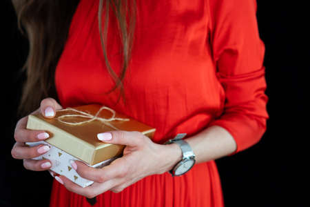 girl in red dress with long hair with gift boxの写真素材