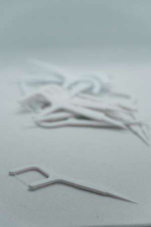 white floss sticks on white background