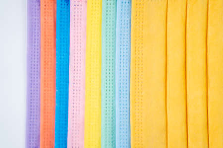 multicolored protective masks on a white backgroundの写真素材