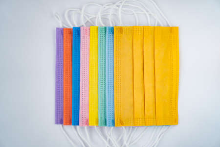 multicolored protective masks on a white backgroundの写真素材