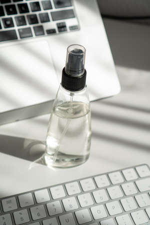 a jar of sanitizer on an office table among computer technologyの写真素材