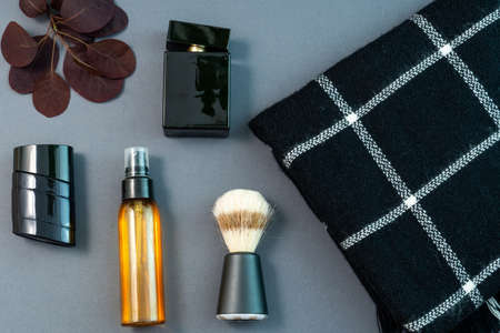 mens flat lay: fashionable black candle, mens perfume, black scarf and shaving cosmeticsの写真素材