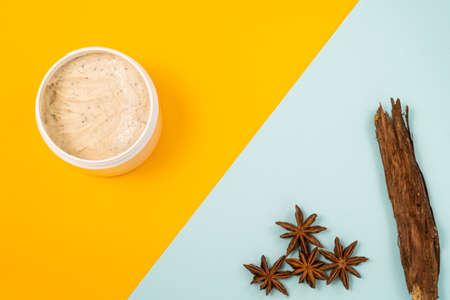 body scrub and natural elements on orange-blue backgroundの写真素材