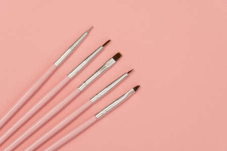 cosmetic flat lay: pink makeup brushes on pink backgroundの写真素材