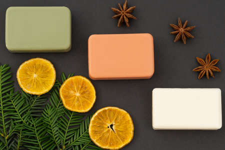 cosmetic flat lay: craft soap of white, green and red colors with natural elements on a gray backgroundの写真素材