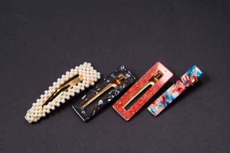 hair clips of different colors and different styles on a dark background