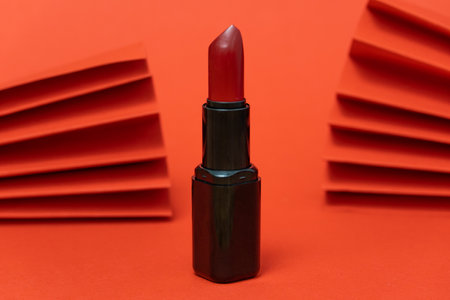 fashion flatlay photo of cosmetics beauty products lipstick on red backgroundの写真素材