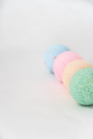 bathroom bombs green, pink, cream and blue on a white background