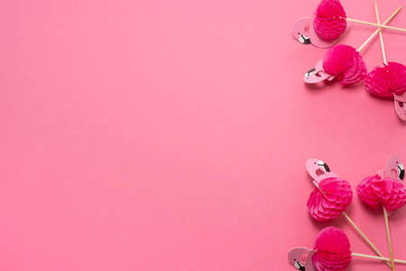 pink party toothpicks in a shape of flamingo on a pink background. origamiの写真素材