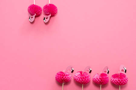 pink party toothpicks in a shape of flamingo on a pink background. origamiの写真素材
