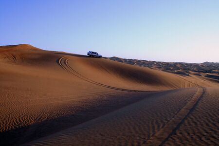 Desert Safari dune bashing near Dubai, at Sunset.の写真素材