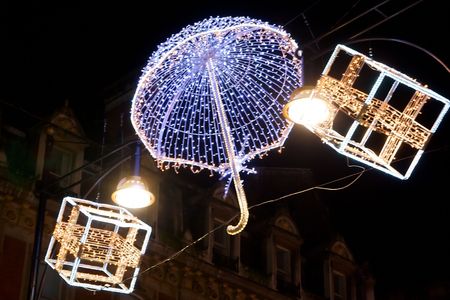 Chistmas decoration, with umbrella and gifts,  on the streets of London, UK at night.の写真素材