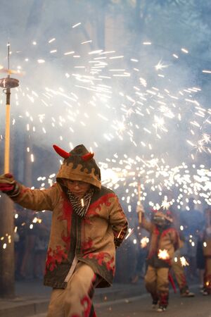 BARCELONA - AUGUST 21: Fire devils in the fire-run (Correfoc) as part of the Gracia Festival 2011...