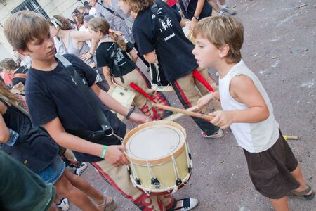 BARCELONA - AUGUST 21: Traditional drums band (gralla) in the Gracia Festival 2011 (La Festa Major de Gracia 2011) on August 21, 2011 in Vila de Gracia, Barcelona, Spainのeditorial素材