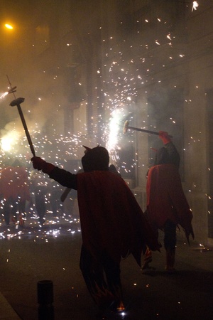 BARCELONA - AUGUST 21: Fire devils in the fire-run (Correfoc) as part of the Gracia Festival 2011...