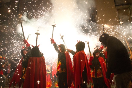 BARCELONA - AUGUST 21: Fire devils in the fire-run (Correfoc) as part of the Gracia Festival 2011...