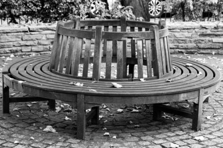Black and white image of a round wooden benchのeditorial素材