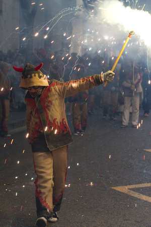BARCELONA - AUGUST 21: Fire devils in the fire-run (Correfoc) as part of the Gracia Festival 2011...