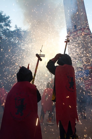 BARCELONA - AUGUST 21: Fire devils in the fire-run (Correfoc) as part of the Gracia Festival 2011 (La Festa Major de Gracia 2011) on August 21/22, 2011 in Vila de Gracia, Barcelona, Spainのeditorial素材