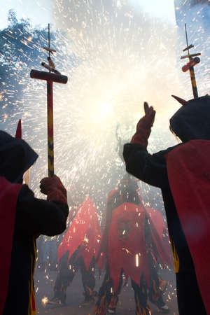 BARCELONA - AUGUST 21: Fire devils in the fire-run (Correfoc) as part of the Gracia Festival 2011 (La Festa Major de Gracia 2011) on August 21/22, 2011 in Vila de Gracia, Barcelona, Spainのeditorial素材